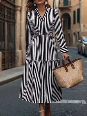 Notched long-sleeve midi dress in black and white stripe with a tiered skirt.