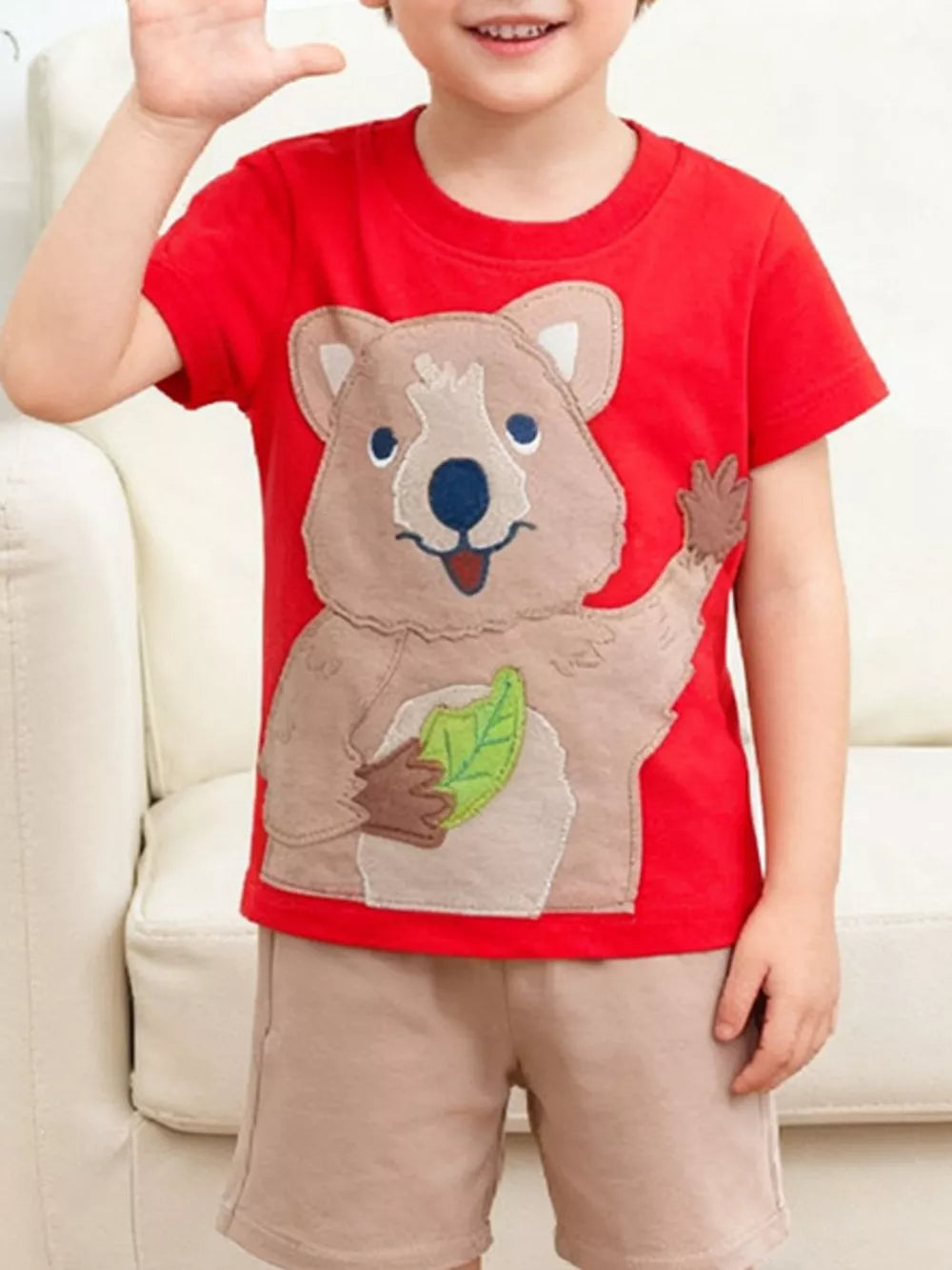 Red toddler t-shirt with playful quokka appliqué and leaf detail.