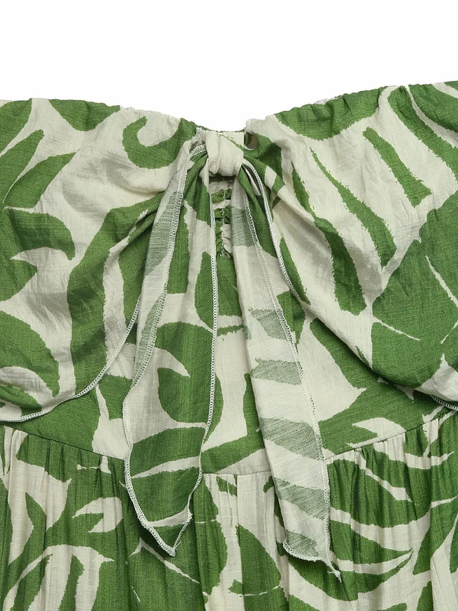 Tropical tie-front strapless maternity jumpsuit with green leaf print and tie detail.