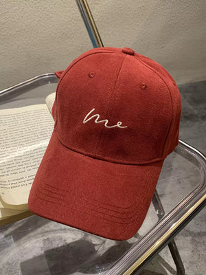 Wine red cotton baseball cap with embroidered "me" detail and curved brim.