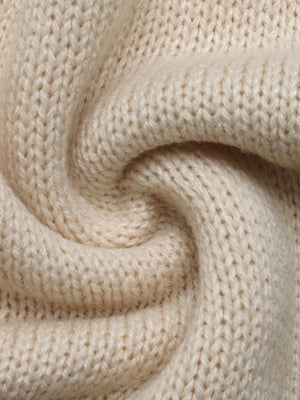 Cream acrylic knit cardigan detail showing textured stitches and soft fabric.