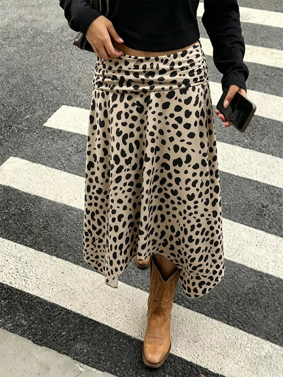 Leopard print midi skirt with asymmetrical hem and ruched waist detail.