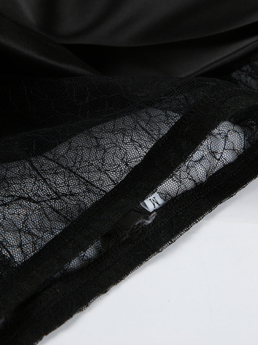 Black midi skirt with sheer lace panel detail and satin fabric.