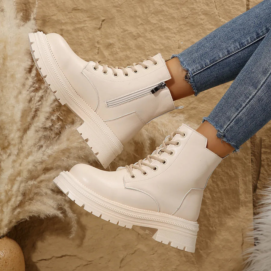 Beige combat boots with side zip detail and lace-up front.