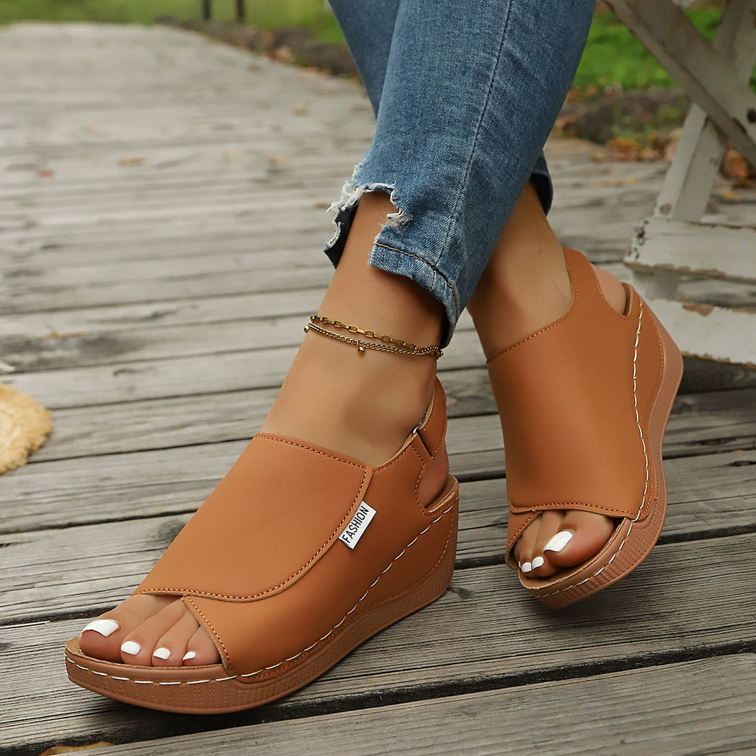 Brown open-toe wedge sandals with white stitching and "Fashion" label.