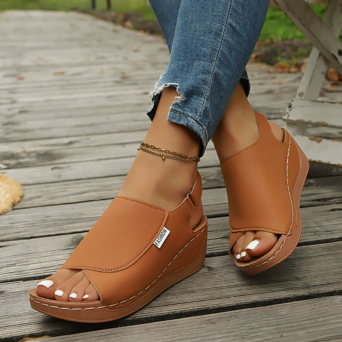 Brown open-toe wedge sandals with white stitching and "Fashion" label.