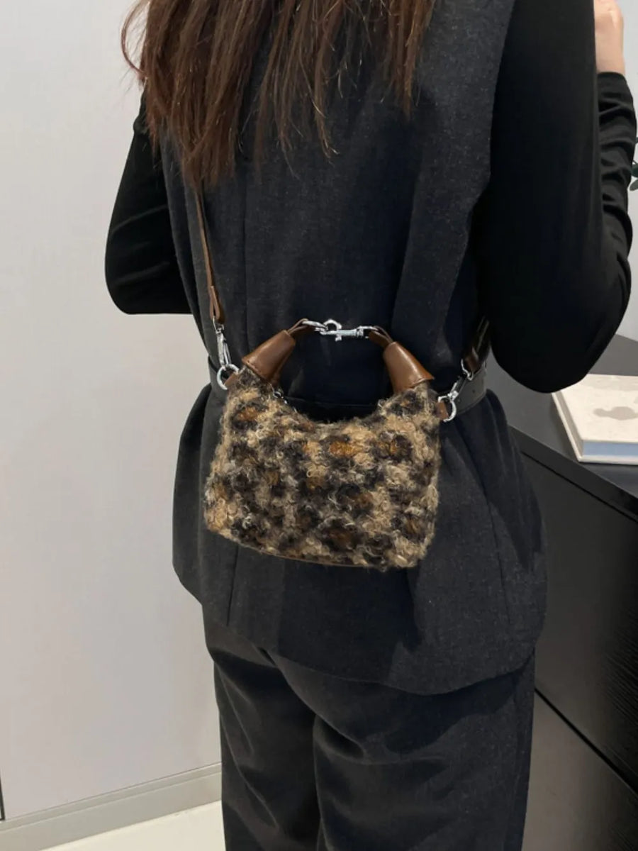 Shearling check mini shoulder bag with brown leather handles and silver hardware.