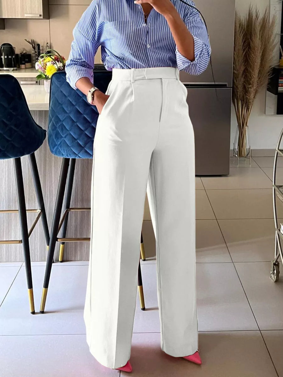 Ivory white high-waisted wide-leg trousers with a belted waist and a relaxed fit.