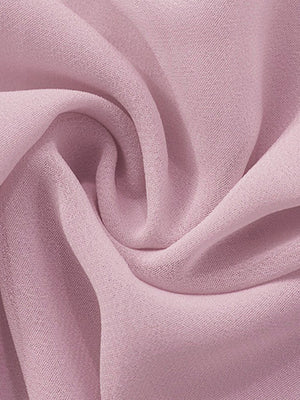 Sheer chiffon mini dress fabric in a soft pink, showing draped texture.