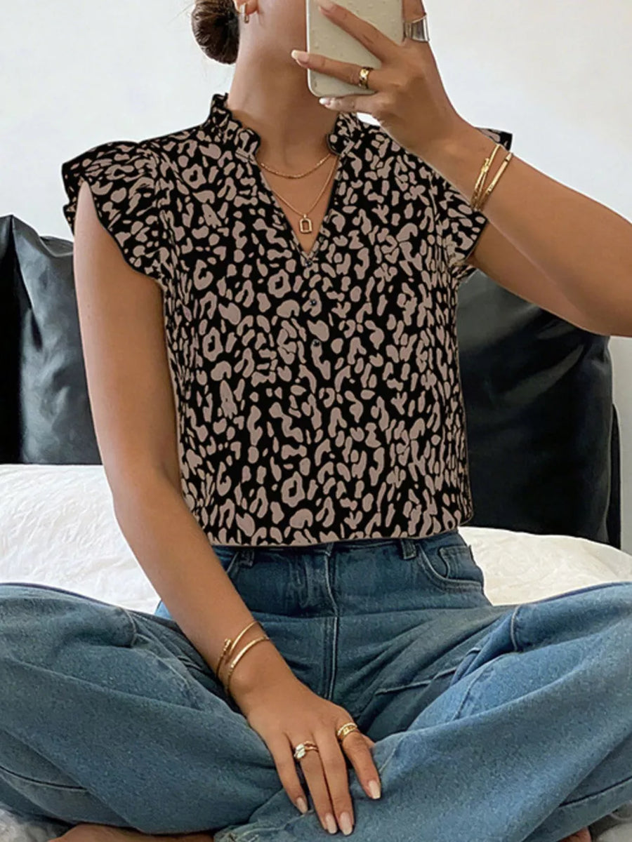 Leopard print ruffle sleeve top with mock neck and v-neck detail.
