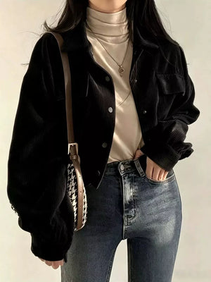 trucker jacket in black featuring collared and relaxed fit
