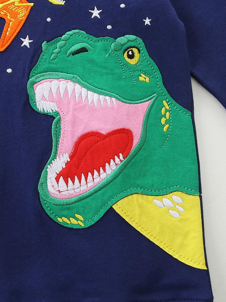 Toddler navy cotton long sleeve top with a green dinosaur appliqué and stars.