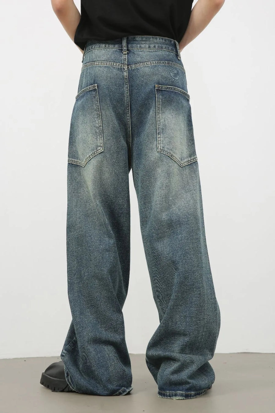 Distressed denim wide leg jeans for men in medium wash, featuring a relaxed fit and vintage wash.