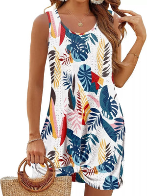 Eyelet tank dress with multicolor tropical leaf print and twisted hem detail.
