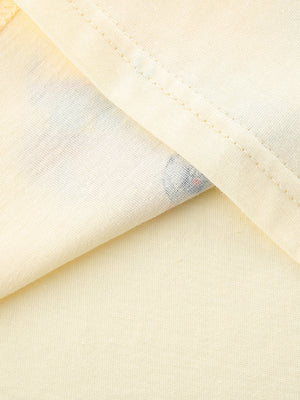 Toddler cream cotton t-shirt with a peek of colorful vehicle print.