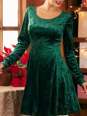 Green velvet a-line gown with round neck and long sleeves.