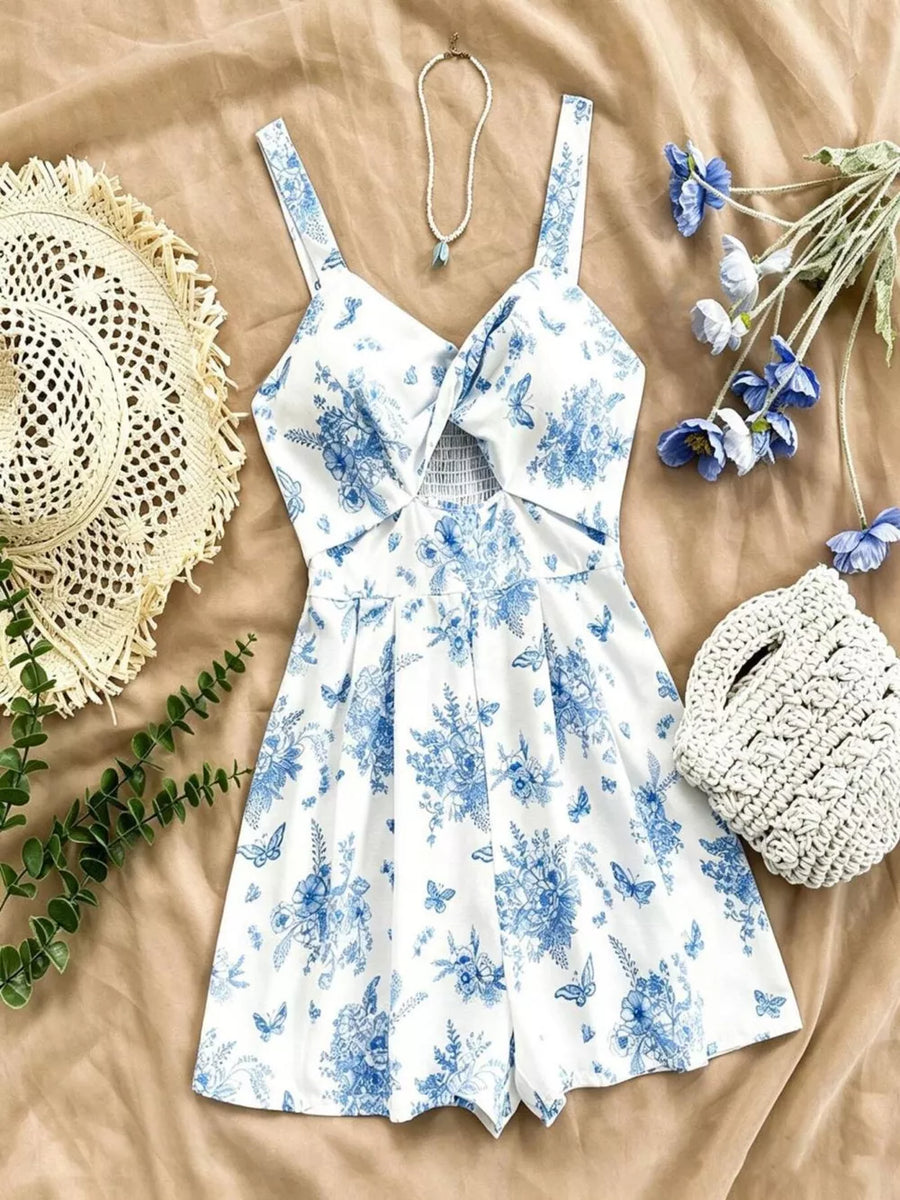 White floral and butterfly print romper with twist front and cutout detail.