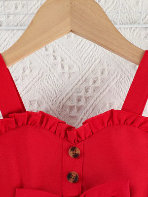 Red baby top with ruffle trim, sweetheart neckline, and button detail.