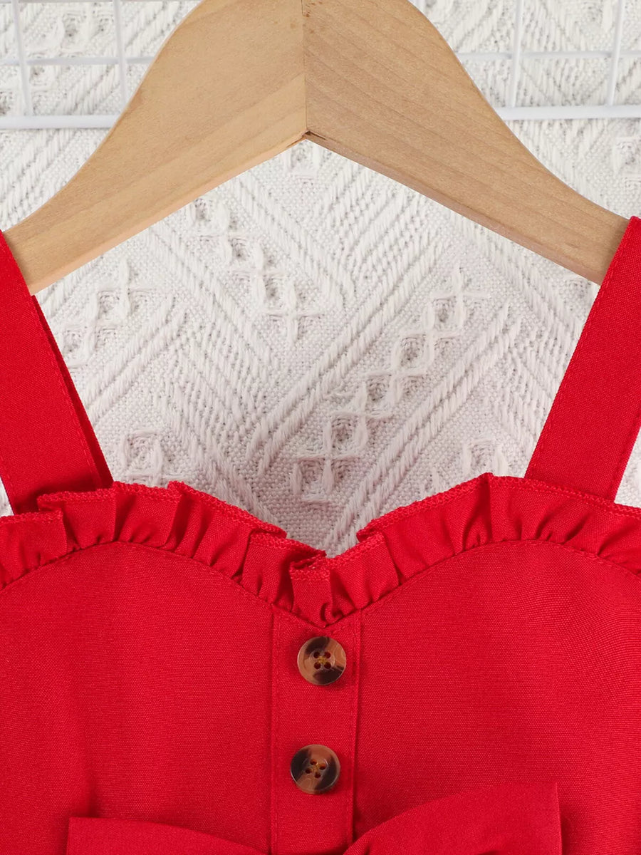 Red baby top with ruffle trim, sweetheart neckline, and button detail.