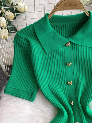 Green ribbed knit midi dress with collar and gold butterfly buttons.