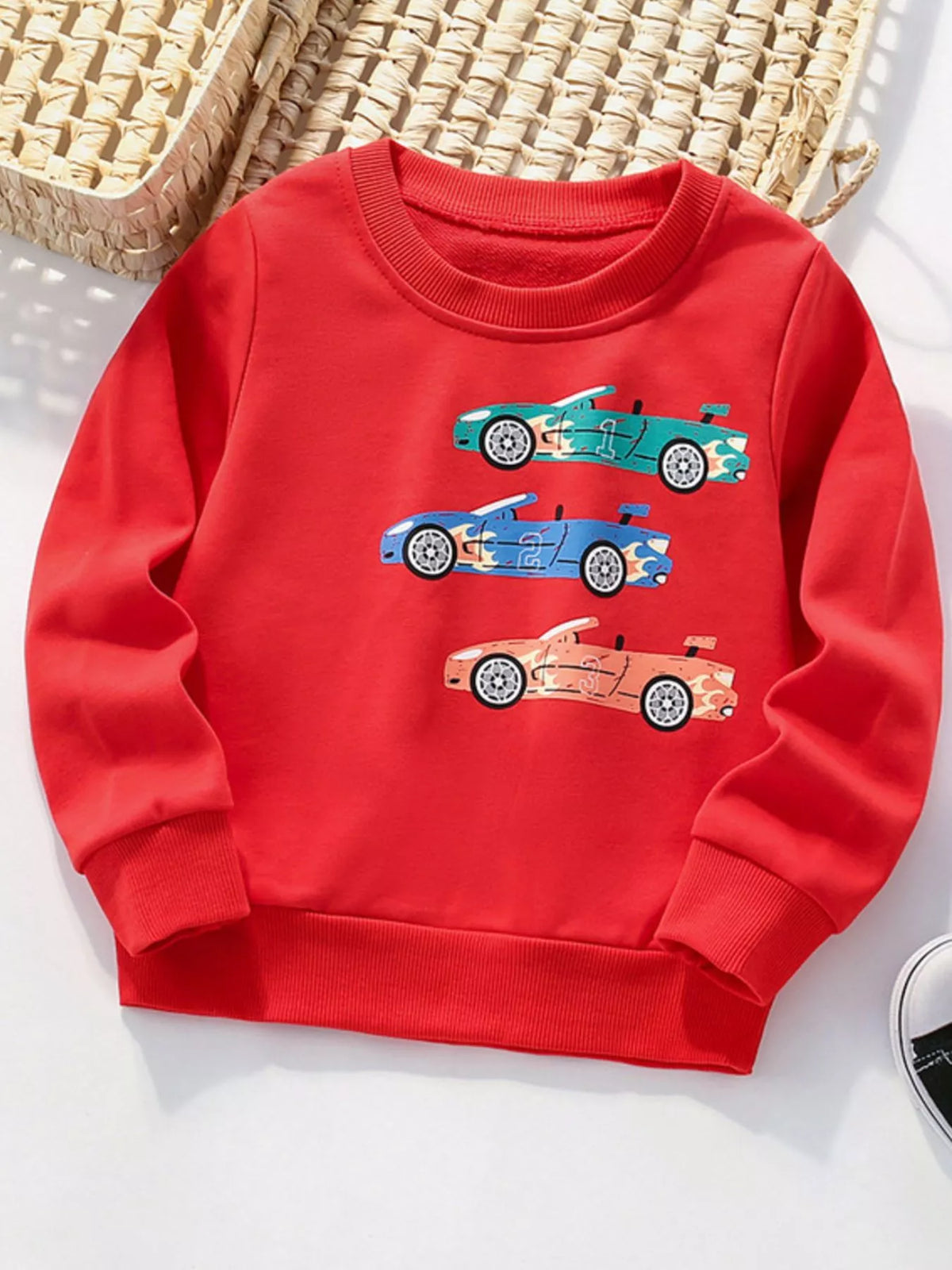 Kids' red crew neck sweatshirt with car print, cotton fabric, long sleeves.