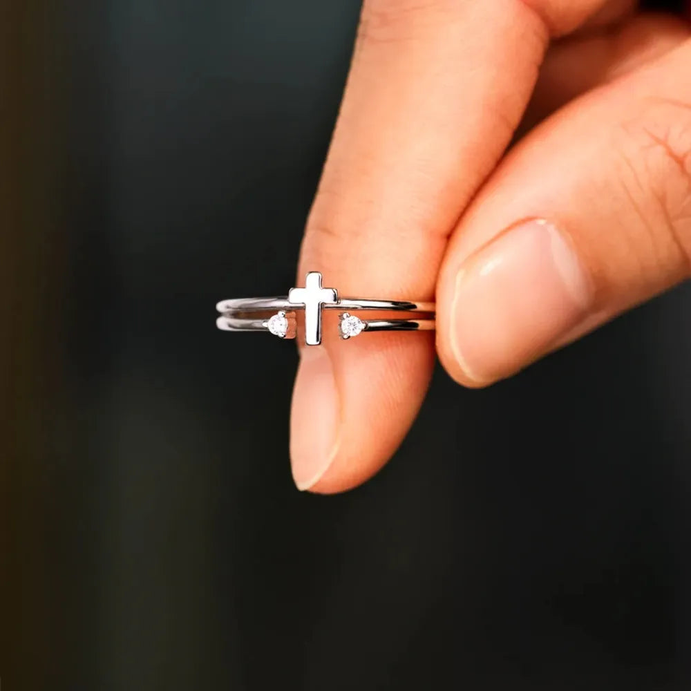 Double band silver ring with a cross and two crystals.