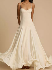 Elegant ivory sweetheart neck maxi dress with flowing skirt and spaghetti straps.