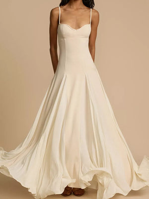 Elegant ivory sweetheart neck maxi dress with flowing skirt and spaghetti straps.