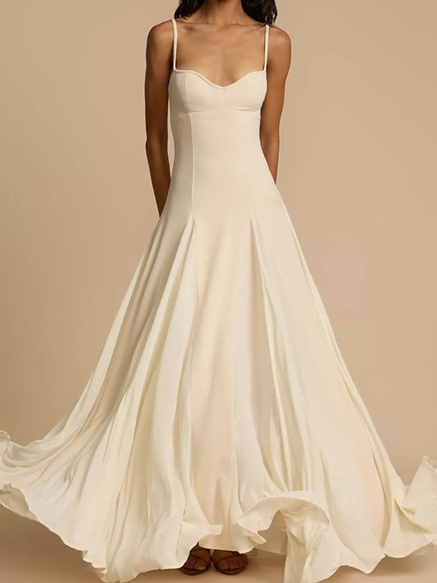 Elegant ivory sweetheart neck maxi dress with flowing skirt and spaghetti straps.