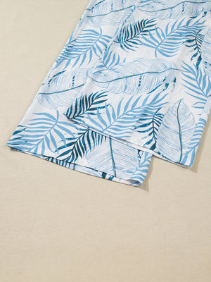 Tropical leaf print wide leg pants in white with blue foliage pattern, cotton.