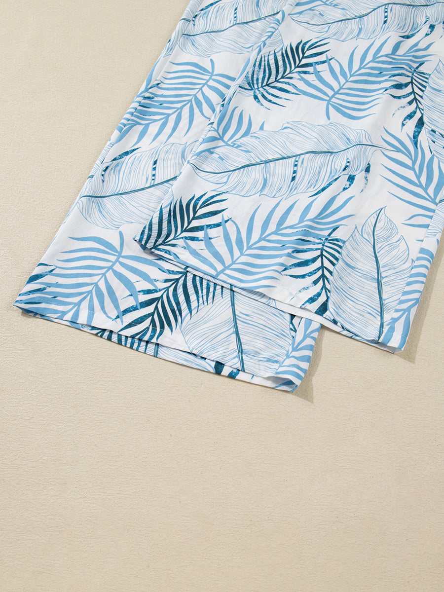 Tropical leaf print wide leg pants in white with blue foliage pattern, cotton.