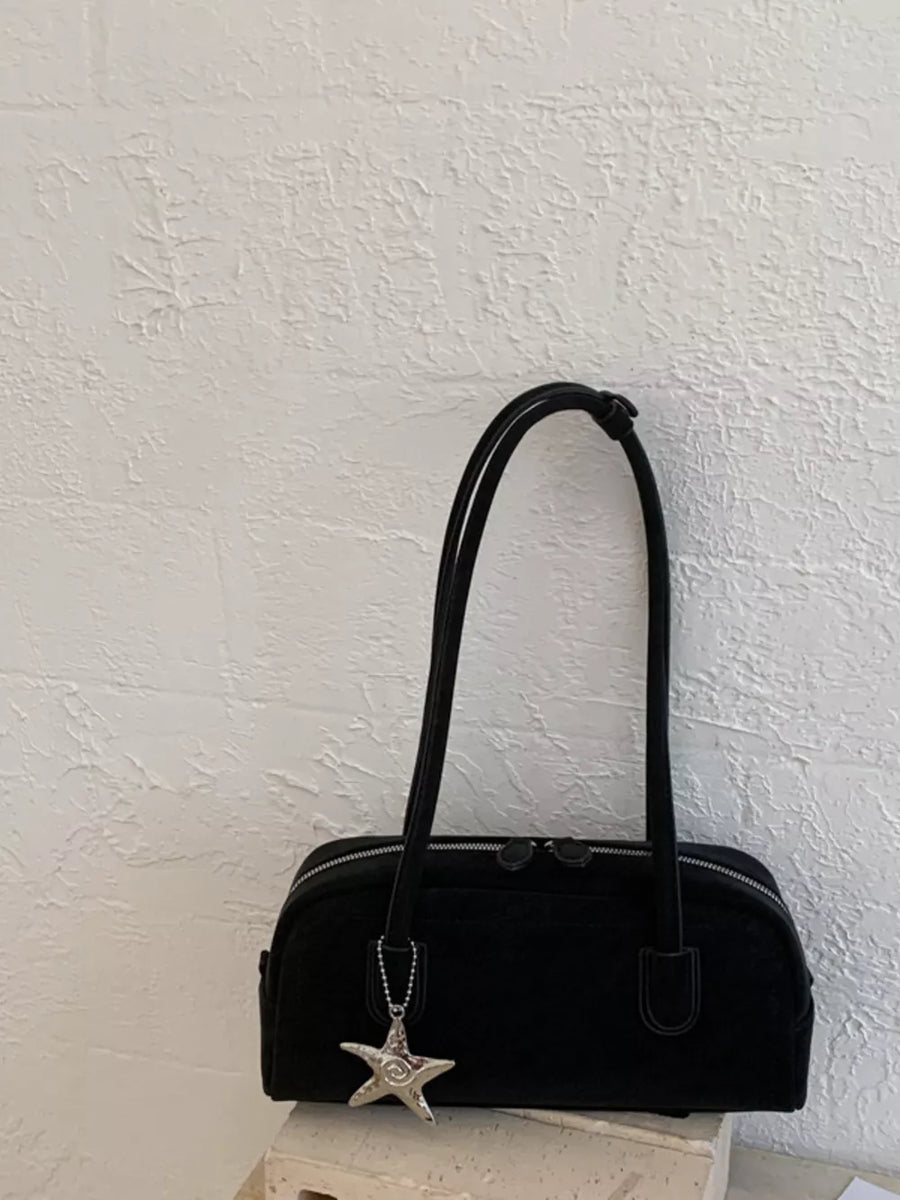 Black shoulder bag with star charm and double zipper closure