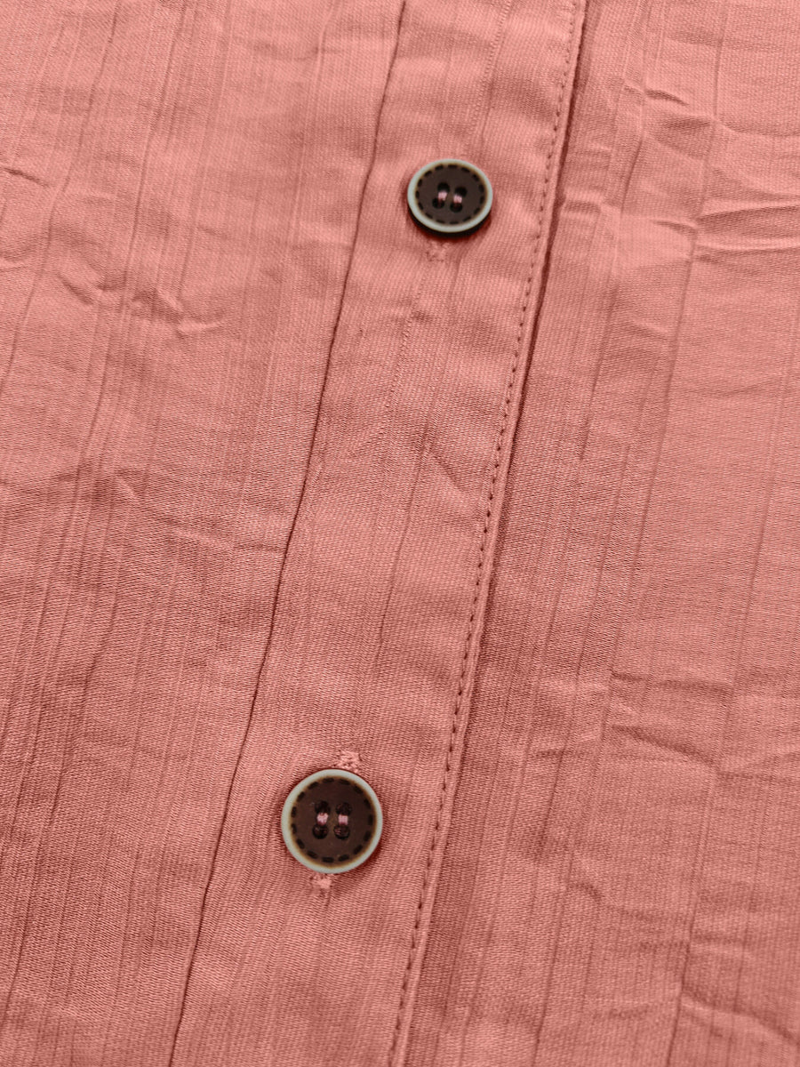100% polyester Care instructions: Machine wash cold button-down shirt in coral pink with relaxed silhouette