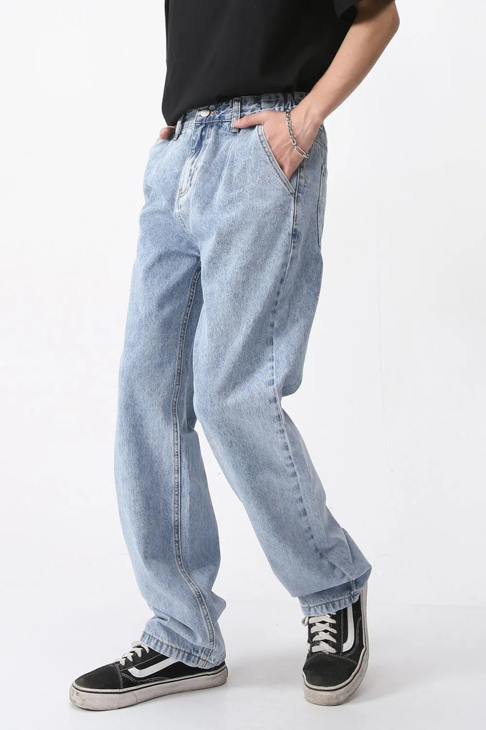 Pleated denim wide-leg trousers in medium wash, featuring a relaxed fit and casual styling.