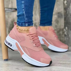 Pink lace up air cushion sneakers with white chunky sole and visible air bubble detail.