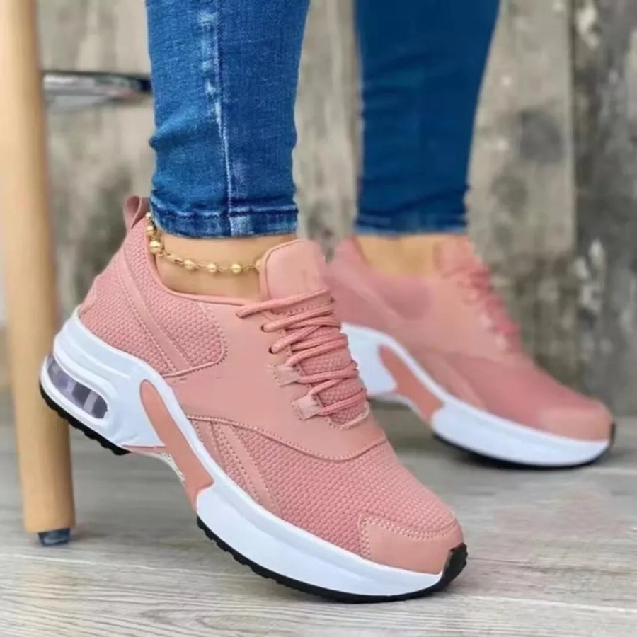 Pink lace up air cushion sneakers with white chunky sole and visible air bubble detail.