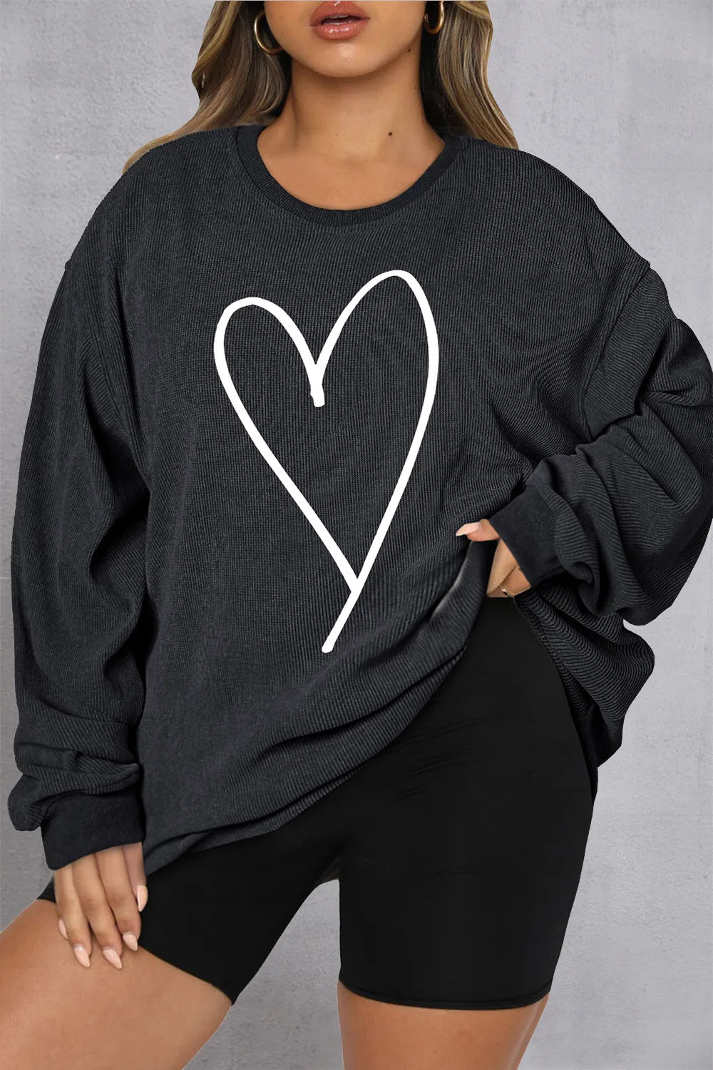Black ribbed crewneck sweatshirt with white heart outline detail