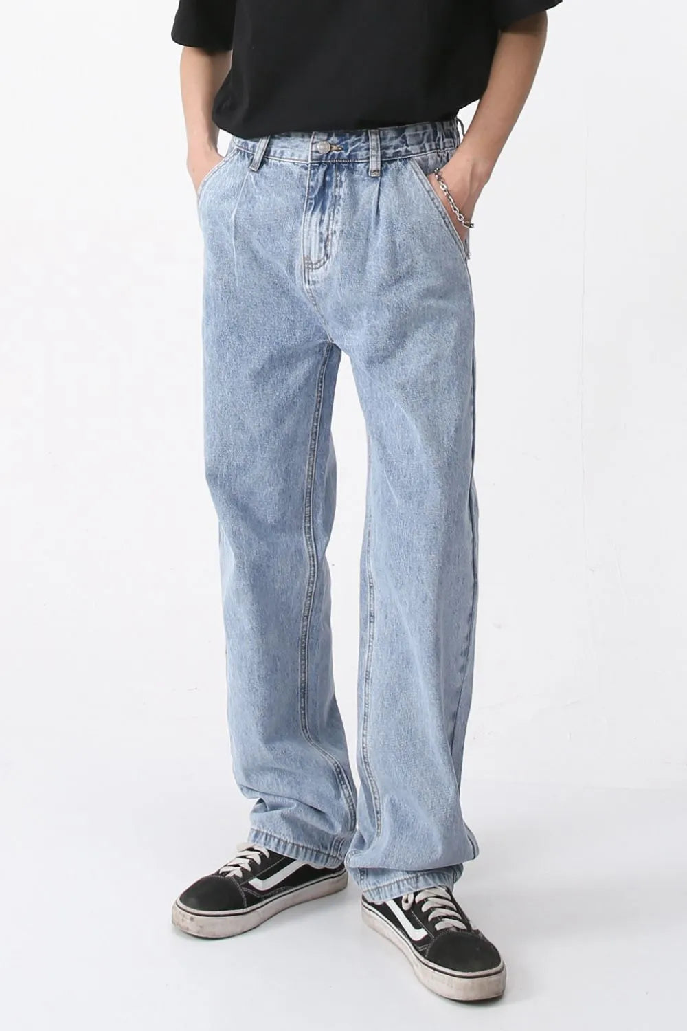 Pleated denim wide-leg trousers in medium wash, featuring a relaxed fit and casual style.