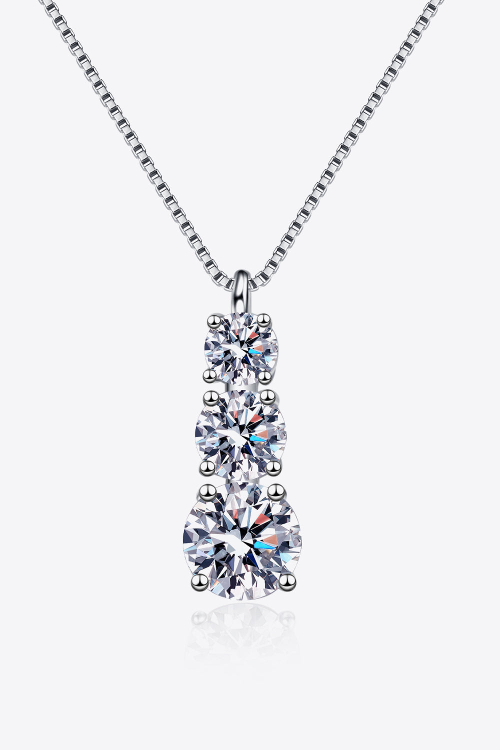 Silver moissanite cascade pendant necklace with three round-cut stones on a box chain.