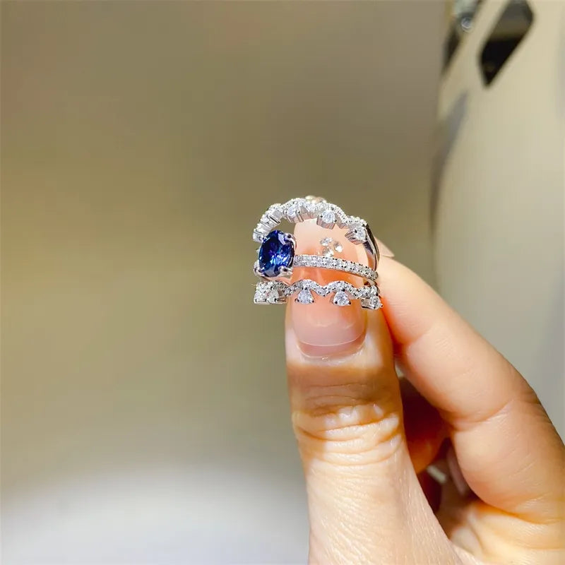 Sapphire and moissanite trio ring set in silver with blue stones.