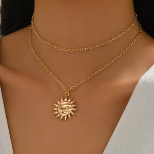 Gold layered necklace with sun and moon pendant