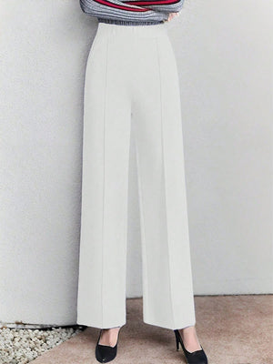 White high-waisted wide leg cotton trousers with pockets, elegant and comfortable.