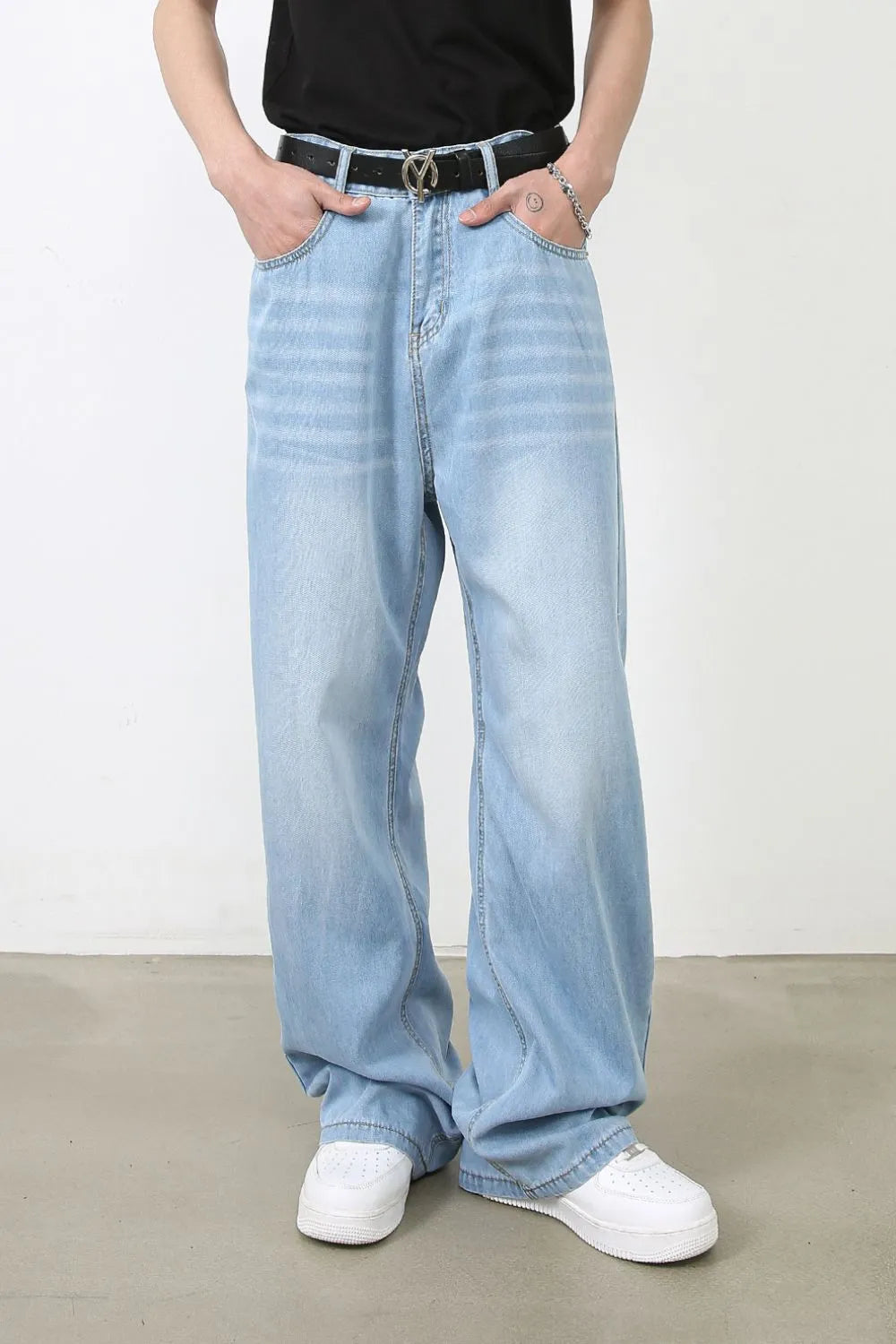 Light blue oversized denim palazzo jeans with a relaxed fit and subtle horizontal whiskering detail.