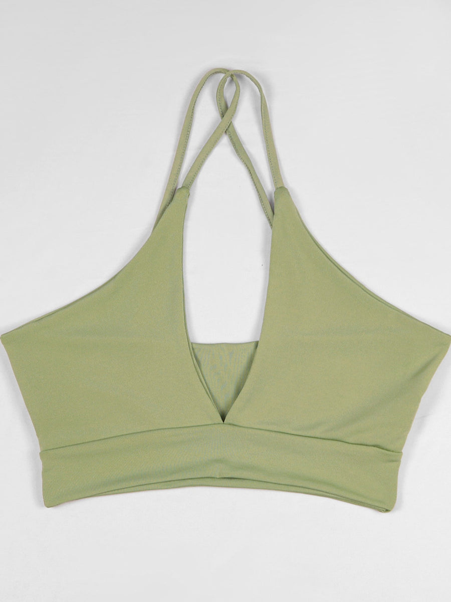 At least 95% polyester with spandex halter top in sage green with fitted silhouette
