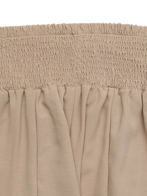 Smocked waist wide leg trousers in beige cotton with a relaxed fit.