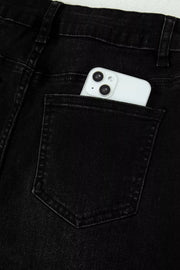 Black high-waisted cropped jeans with raw hem detail, phone in back pocket.