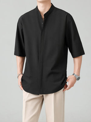 Black oversized mandarin collar half-sleeve shirt with button-down front.