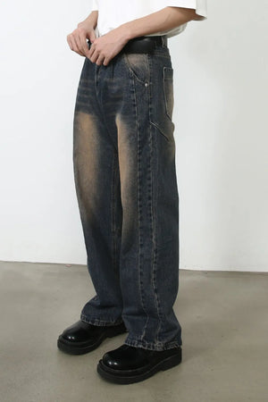 Baggy dark wash denim jeans with faded detailing and a relaxed fit.