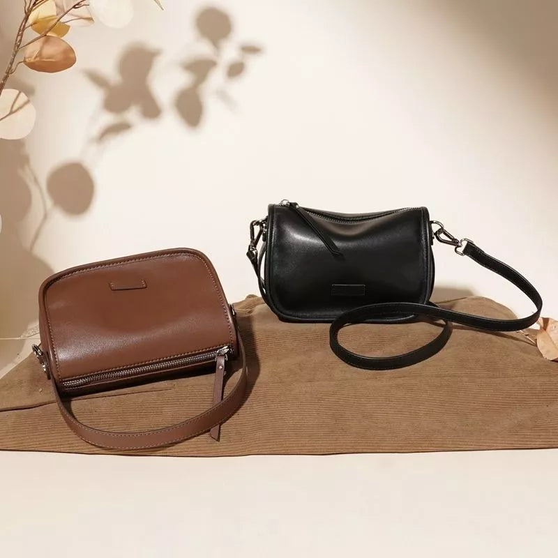 Sleek leather crossbody bags in caramel and black with adjustable straps.