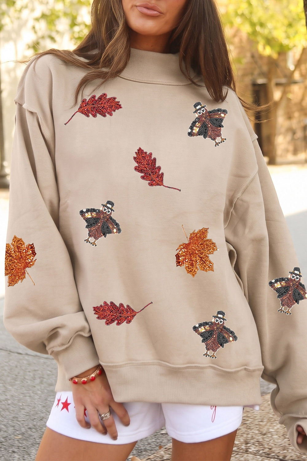 beige sweatshirt with graphic and mock neck